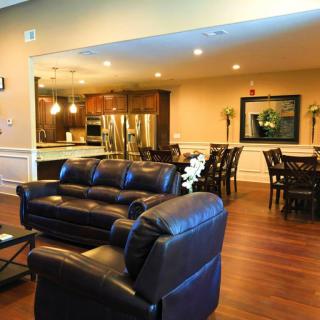 A spacious open floor plan with a comfortable living room, modern kitchen, and dining area.