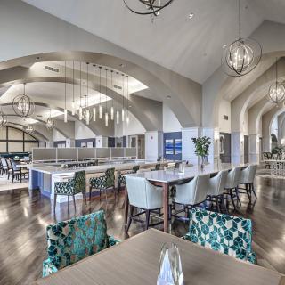A spacious and elegantly designed restaurant interior with modern lighting and seating arrangements.