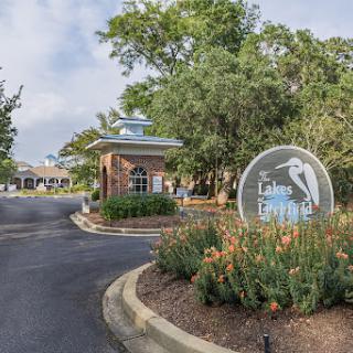 The welcoming entrance to a community with well-maintained landscaping and clear signage.