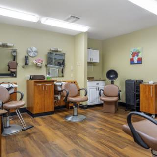 A well-organized hair salon with styling chairs and mirrors.
