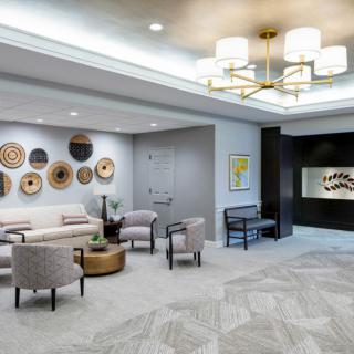 A modern lobby featuring stylish furniture, decorative wall art, and elegant lighting.