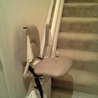 A stairlift installed next to a staircase for accessibility.