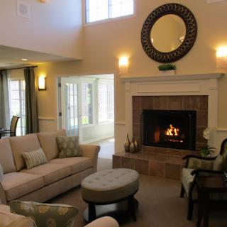 A cozy living room featuring a warm fireplace and inviting furniture.