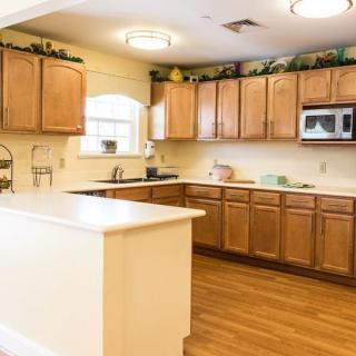 A spacious kitchen with wooden cabinets and a large island.