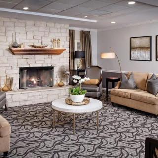 A cozy living room with a fireplace, modern furniture, and stylish decor.