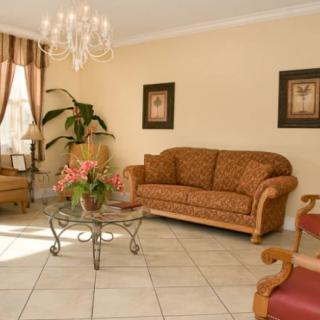 A cozy living room with elegant furniture and a chandelier.
