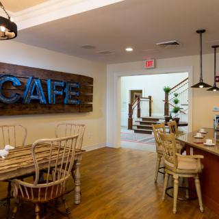 Modern cafe interior with wooden furniture and stylish lighting.