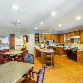 Modern kitchen and dining area with wooden cabinetry and an open layout.