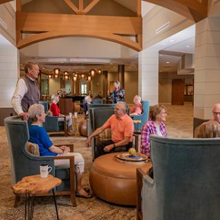 A cozy lounge area filled with people engaged in friendly conversations.