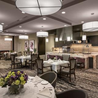 A modern and elegant restaurant dining area with sophisticated lighting and neatly arranged tables.