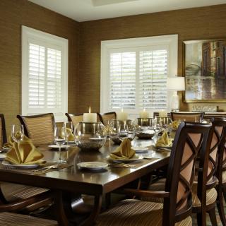 A beautifully set dining room table with elegant decor and comfortable seating.