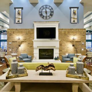 A modern living room featuring a central fireplace, stylish decor, and comfortable seating.
