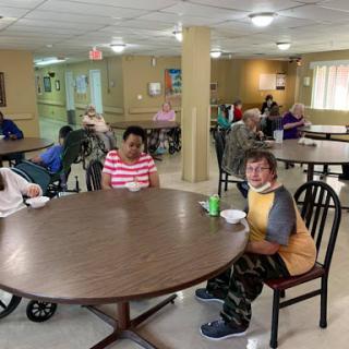 Residents enjoying a meal together in a communal dining area.