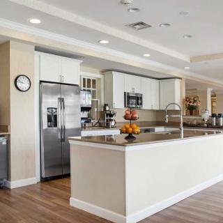 A modern kitchen with a large island and stainless steel appliances.