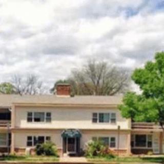 A charming residential house with a welcoming exterior and lush greenery in the front yard.