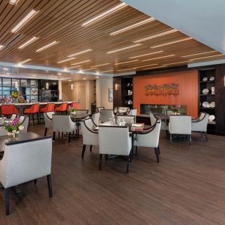 A modern restaurant interior with a stylish dining and bar setup.