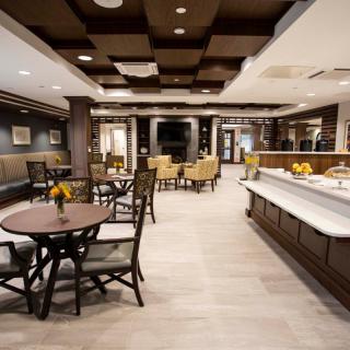 Elegant dining area with well-arranged tables and chairs in a modern restaurant setting.