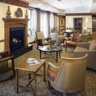 A cozy lounge area featuring a fireplace and comfortable seating.