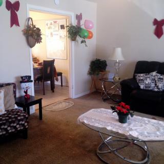 A cozy living room decorated with bows and plants.