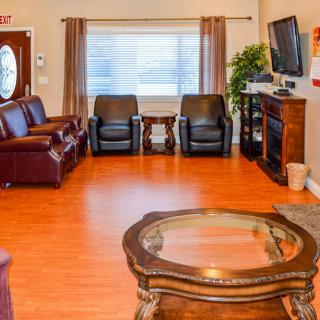 A cozy living room with comfortable seating and a fireplace.