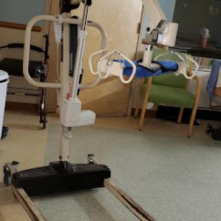 A patient lift system designed for assisting individuals with mobility challenges in a healthcare setting.