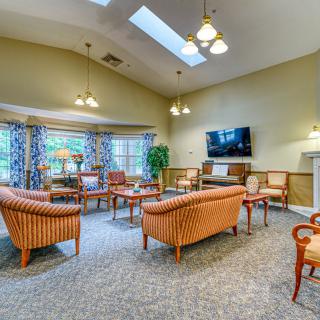 A cozy living room with comfortable seating and a mounted television.