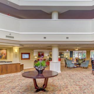 A spacious and elegantly designed lobby with a central table and seating area.