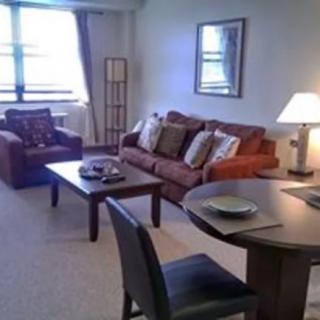 A cozy living room with comfortable seating and warm lighting.
