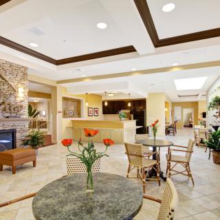 A welcoming hotel lobby with comfortable seating, a fireplace, and elegant interior decor.