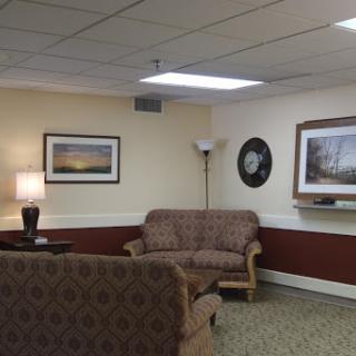 A cozy living room featuring comfortable seating and decorative wall art.