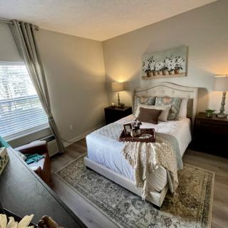 A cozy, modern bedroom with elegant decor and natural lighting.