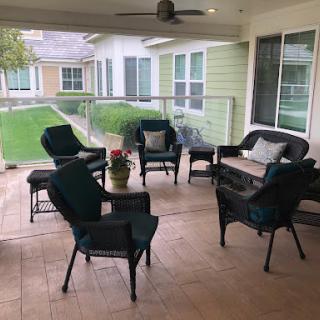 A cozy outdoor seating area with comfortable chairs and a coffee table, perfect for enjoying the fresh air.