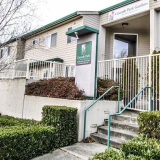 Entrance of a residential apartment building with stairs and handrails.