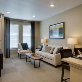 A cozy living room with a comfortable sofa, coffee table, and ambient lighting.