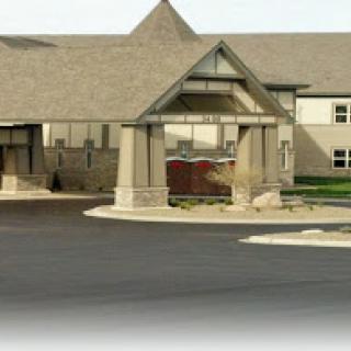A modern building featuring a welcoming entrance and driveway.
