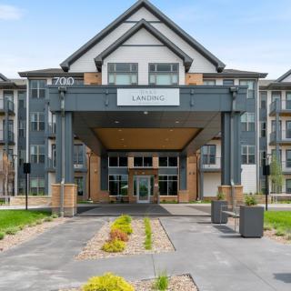 Modern residential building entrance with landscaped pathway.