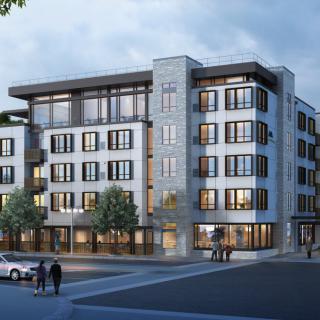 A modern residential building in an urban setting during the evening.