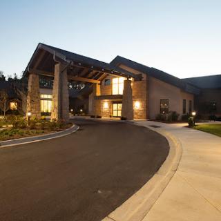 A welcoming entrance to a modern building, illuminated during the evening.