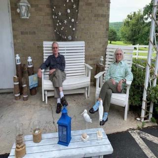 Two friends enjoying a relaxed afternoon on the porch.