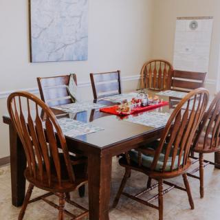 A cozy dining area with a wooden table set for a meal.
