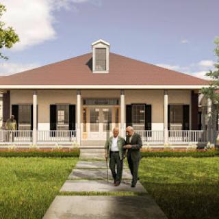 A couple walking together towards their charming modern house, surrounded by lush greenery.