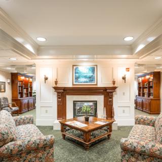 A cozy and elegantly decorated living room featuring a fireplace and comfortable seating.