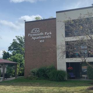 Exterior view of Plymouth Park Apartments showcasing its brick facade.