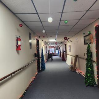 A decorated hallway for the Christmas season, featuring colorful lights and holiday decor.