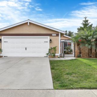 A suburban house with a two-car garage and a well-maintained lawn.