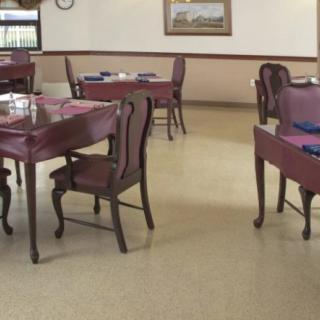 An empty restaurant dining area with neatly arranged tables and chairs.