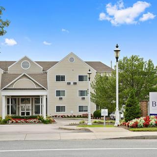 Front view of a hotel with a welcoming entrance and landscaped surroundings.