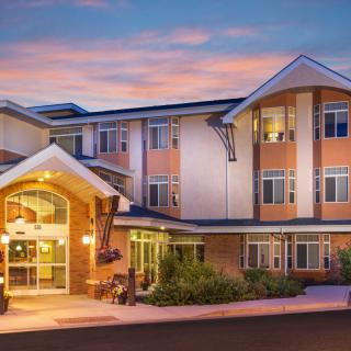 A modern hotel building with a well-lit entrance during the evening.