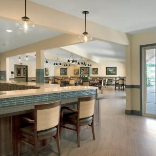 A modern dining area with bar seating and elegant lighting.