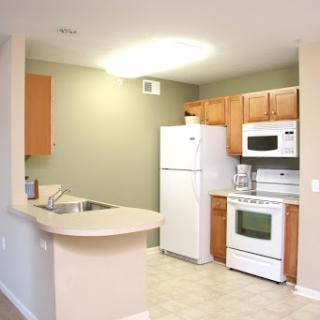 A modern kitchen featuring essential appliances and a spacious countertop.